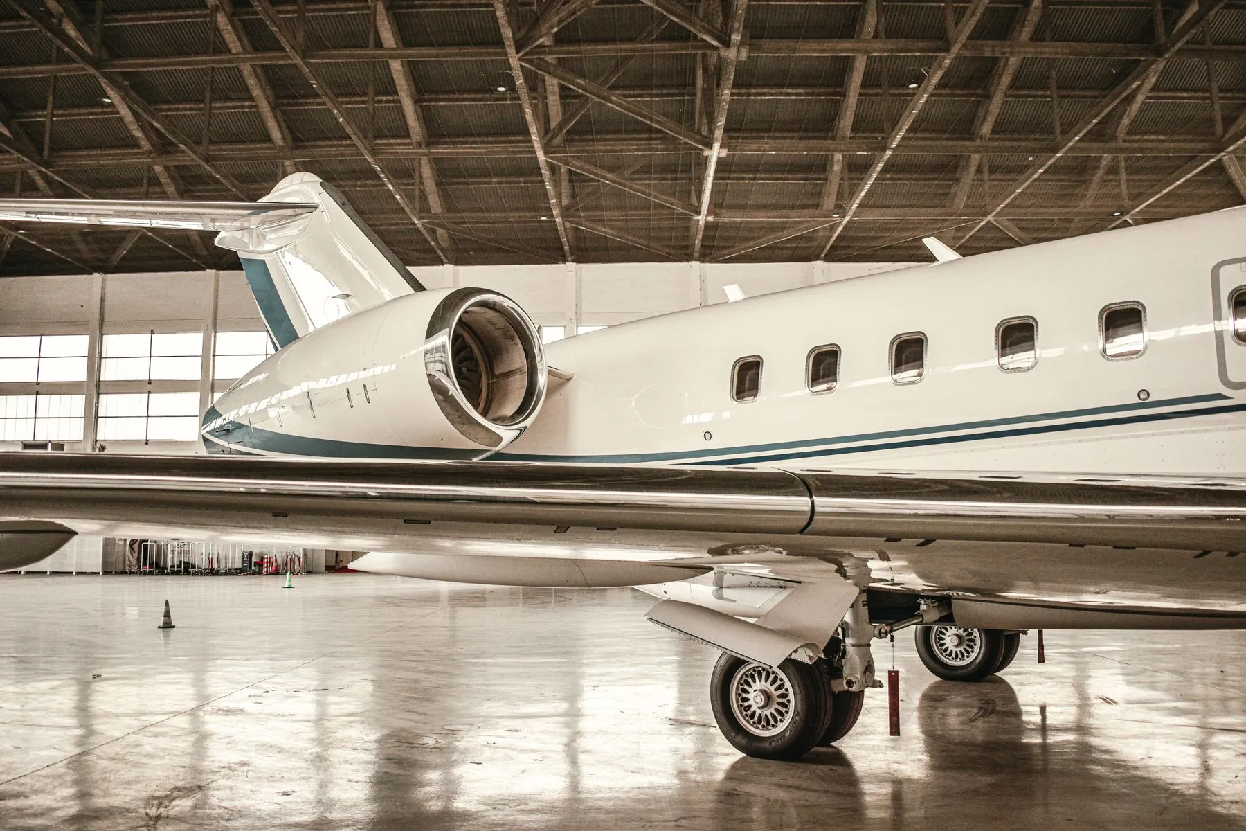 Business jet with engine and landing gear detail inside a hangar