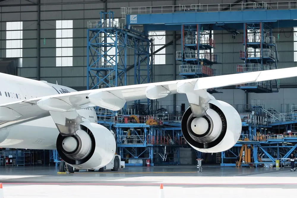 Aircraft undergoing maintenance inside an MRO hangar